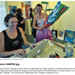 Donia Lilly and Caylin Spear setting up Women Artists of Kauai exhibit