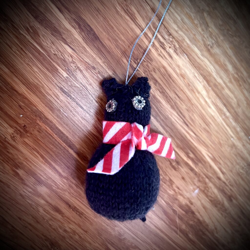 Black cat with scarf ornament