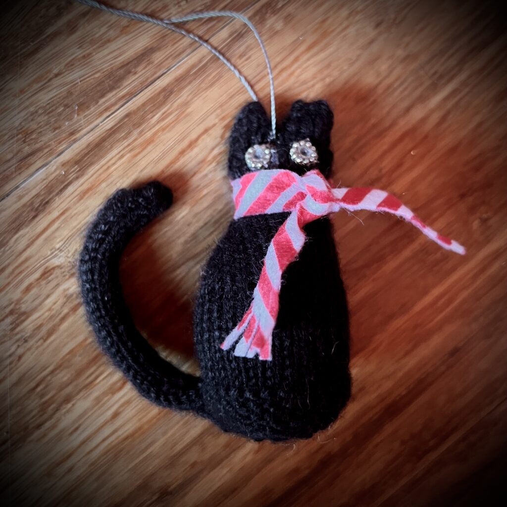 Black cat with candy cane scarf ornament